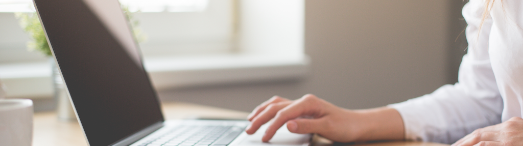 business woman writing with laptop