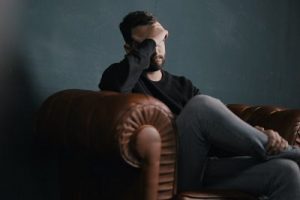 Discouraged man sitting on the couch