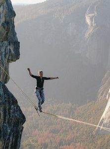 Woman balancing on a rope in a canyon
