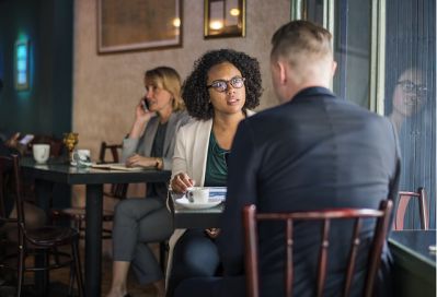 A Woman and a man meeting face to face in a cafe